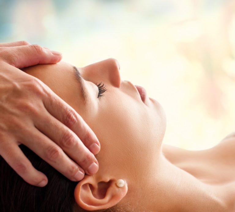 therapist hands on patients head, scalp massage