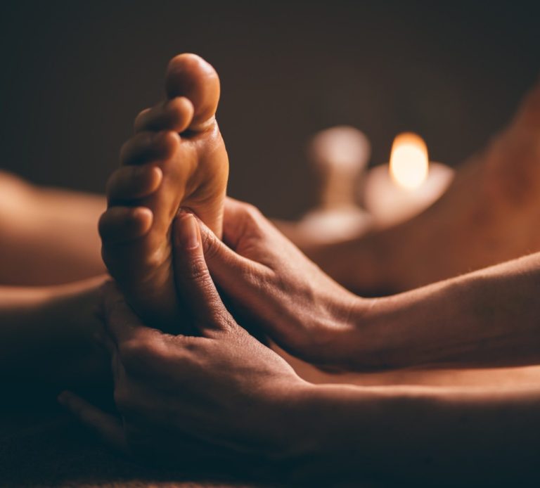 foot massage, massage therapy, hands on the feet